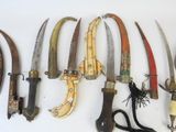 a lot of different types of knives on the wall