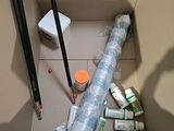 a cardboard box filled with different types of paint and brushes
