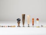 several different types of baseball bats are lined up on a white surface