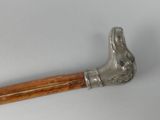 a metal hammer with a wooden handle on a white surface