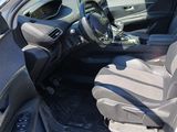 the interior of a car with the door open and the driver ' s seat down