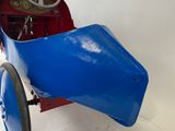 a blue pedal car with a steering and a steering wheel