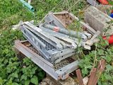 a pile of junk sitting in the grass next to a building