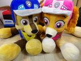 two stuffed animals sitting next to each other on a table