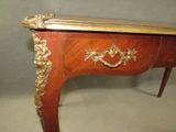 a wooden table with a gold decoration on top of it