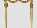 a gold console table with a marble top