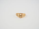 a yellow gold ring with a heart shaped diamond