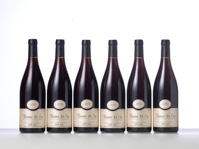 six bottles of wine lined up in a row on a table