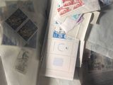 many different stamps on a piece of paper in a suitcase