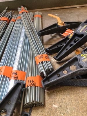 many different types of steel pipes on the floor