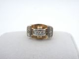 a close up of a diamond ring on a white surface