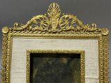 a picture of a gold picture frame with a picture in it