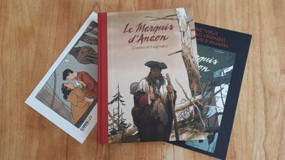 two books that are sitting on a wooden table