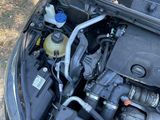 the engine of a car with a bottle of water in the hood