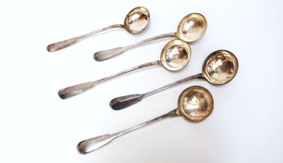 six silver spoons are lined up in a row on a white surface