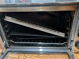 a toaster oven that is open on a wooden table