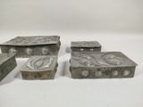 three silver metal boxes sitting next to each other on a white surface