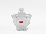 clear glass jar with a lid and a red label on it