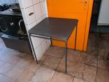 a small table in the corner of a small kitchen