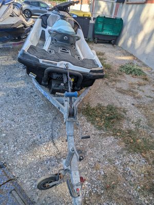 a boat that is sitting on a trailer in the yard