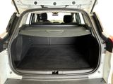 the back of a car with the trunk open and the seats folded down