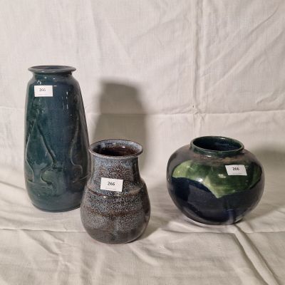 three vases sitting next to each other on a table