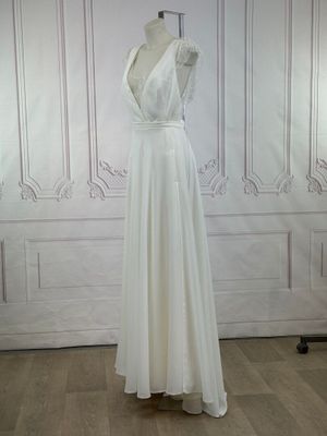 a photo of a white dress on a mannequin stand