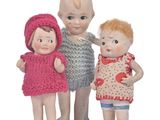 three little dolls that are standing next to each other