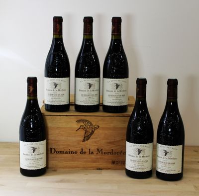 six bottles of wine sit in a wooden box on a table
