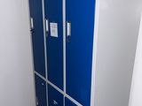 two blue lockers in the corner of a room