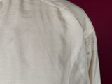 a close up of a white shirt with a red tie