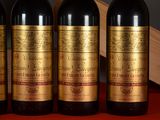 three bottles of wine sitting on top of a table next to a wooden box
