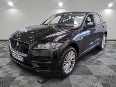 the black jaguar suv is parked on a checkered floor