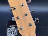 a close up of a guitar with a qr code attached to it