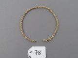 a close up of a gold bracelet with a price tag on it