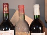 three bottles of wine are lined up on a table