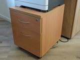 a printer sitting on top of a filing cabinet in a room