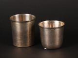 two cups sitting next to each other on a black surface