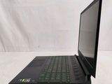 a black laptop with a green keyboard sitting on a white surface