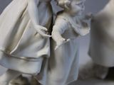 a figurine of a man and a woman with a child