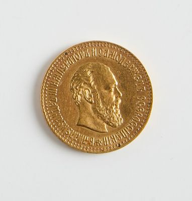 une pièce d'or sur laquelle figure l'image d'un homme