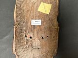 a piece of wood that has a face on it