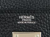 hermes ' s black leather handbag with a gold plate on the front