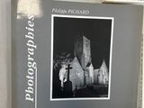 a picture of a book with a picture of a church in the background