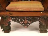 a wooden bench with a cushion on top of it