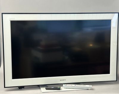 a flat screen tv sitting on a table with a remote
