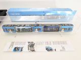 a blue and white train on display in a clear box