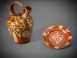 two vases with designs on them sitting next to each other