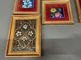 four framed pictures of flowers and flowers are on a table
