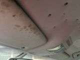a surfboard sticking out of the roof of a car